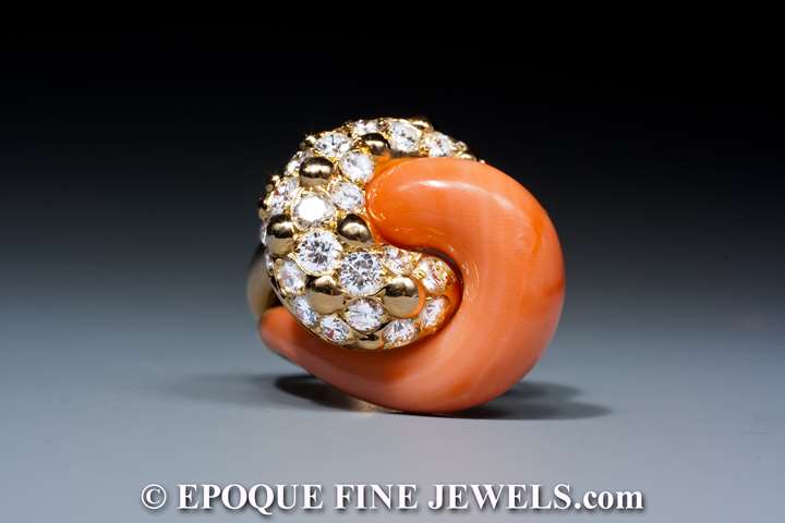 A very fine coral and diamond swirl ring